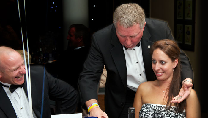 Kevin Bird performing close-up magic table-side at a dinner
